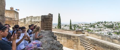High school students looking down at the view from a castle in Seville