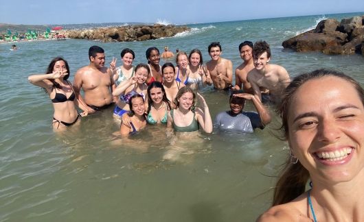 High school students posing in the ocean studying abroad in Rome
