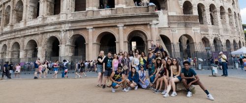 High school students posing in front of the Colosseum in Rome