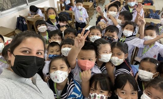 Teacher and students posing for camera in masks
