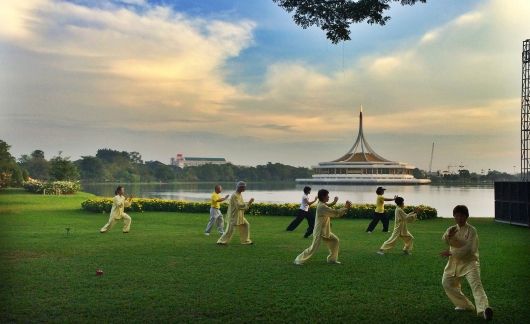 People in Thailand exercising on a lawn